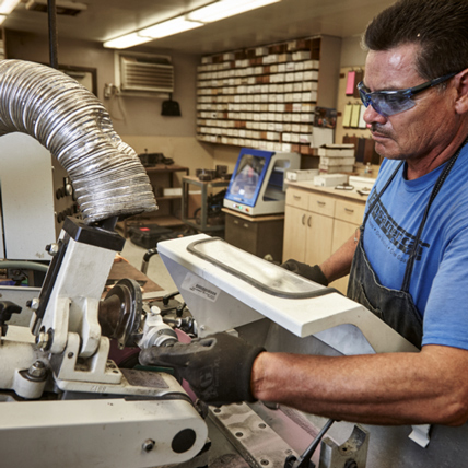 A Ganahl employee cutting custom moulding. 
