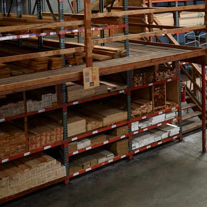 Racks of finished lumber in the covered lumberyard.