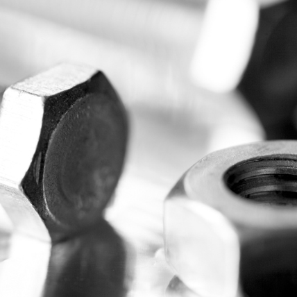A close up of up a screw and a nut. 